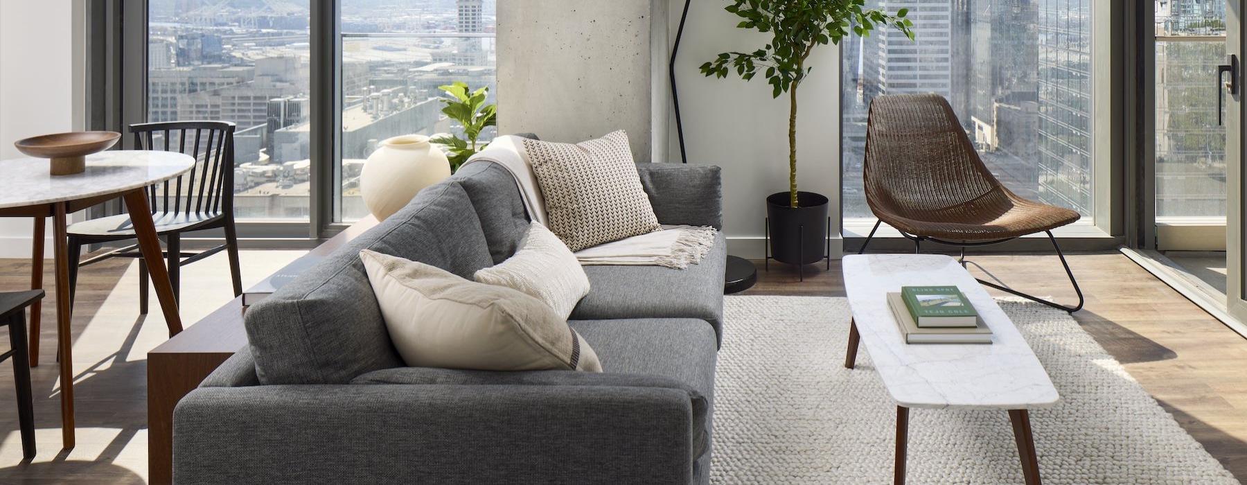 a living room with a couch, tables and chairs