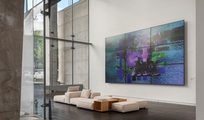 a lounge area with a large couch and a large tv