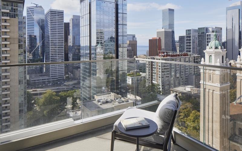 a balcony with a table and chair
